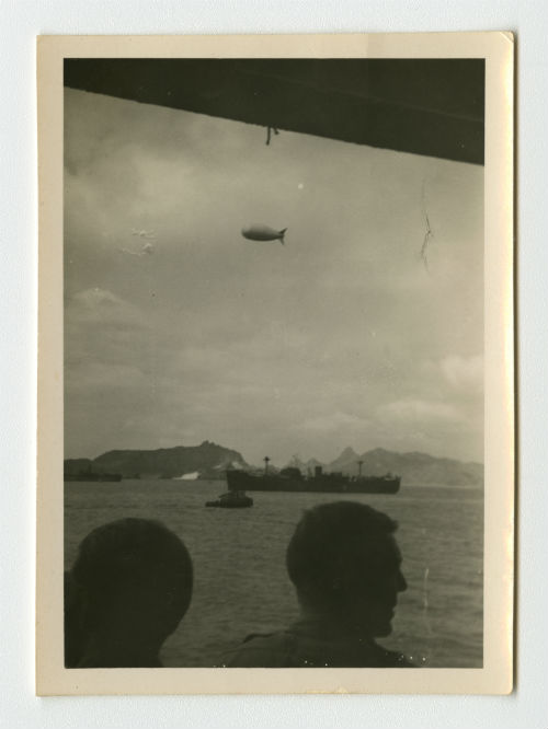 A barrage balloon flying over a ship in Aden, Yemen. Photograph Recto