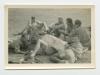 Men reading the newspaper in the Western Desert. Recto