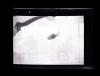 Three men observing a barrage balloon in Aden, Yemen