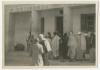 Crowd in front of a public building. Recto