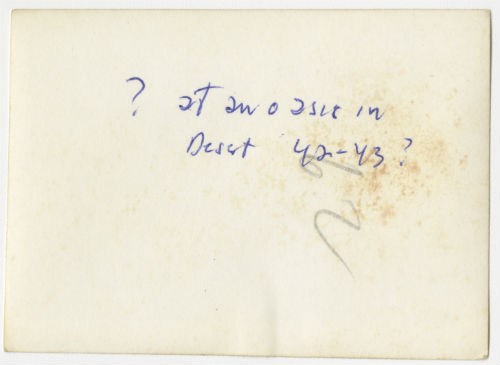 Four men at an oasis in the desert. Verso