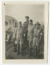 Seven men in uniform in the desert
