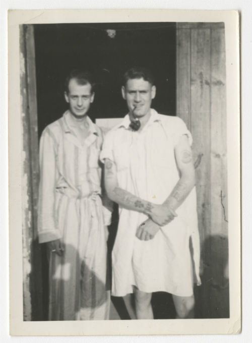 Two men, one of which smoking a pipe