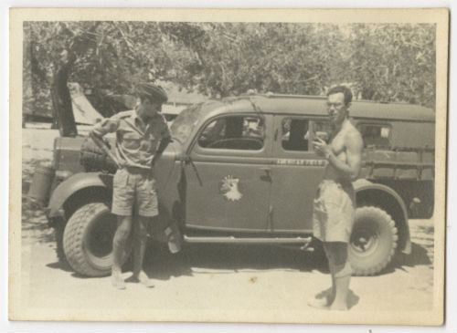 Lester Collins and Arthur Howe, Jr. looking over Art's new car. Recto