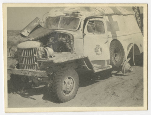 Ambulance that hit a land mine and was knocked end over end. Recto