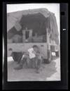 Unidentified individual sitting on the ground