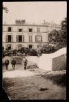 Three men next to a tent in the garden at 21 rue Raynouard